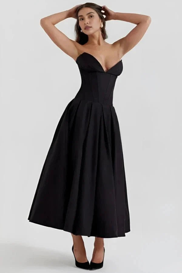 Back view of the Laarni yellow strapless corset midi dress showing the zipper and pleated skirt.